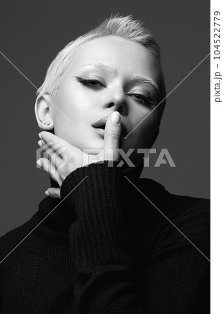 black and white portrait of Short Hair Beautiful young woman with white snow brows 104522779