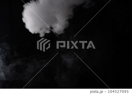 Cloud of white smoke on a black background closeup 104527093