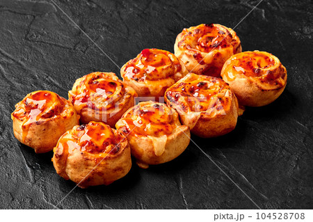 Spicy baked rolls with mozzarella, jalapeno and sweet chili sauce Spicy baked rolls with mozzarella, jalapeno and sweet chili sauce 104528708