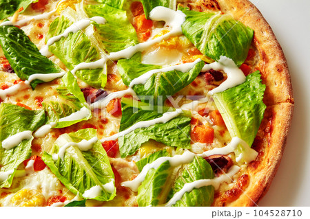 Green lettuce and cream cheese sauce on top of delicious pizza Green lettuce and cream cheese sauce on top of delicious pizza 104528710