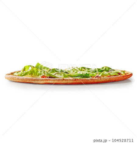 Thin pizza with browned edge topped with lettuce and cream cheese sauce Thin pizza with browned edge topped with lettuce and cream cheese sauce 104528711