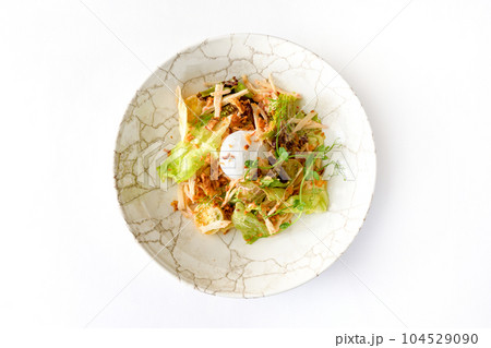 Salad with poached egg, yellow tomatoes, iceberg lettuce and surimi Salad with poached egg, yellow tomatoes, iceberg lettuce and surimi 104529090