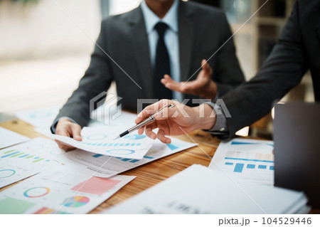 startup Asian business advisor meeting to analyze and discuss the situation on the financial report in the meeting room.Investment Consultant 104529446