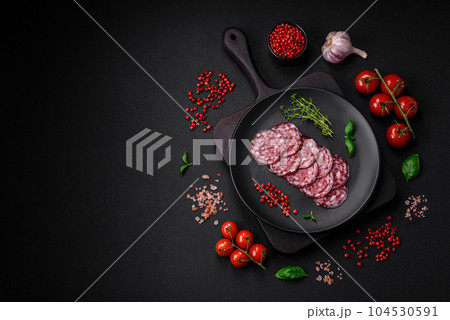 Delicious smoked sausage with bacon, salt, spices and herbs Delicious smoked sausage with bacon, salt, spices and herbs 104530591