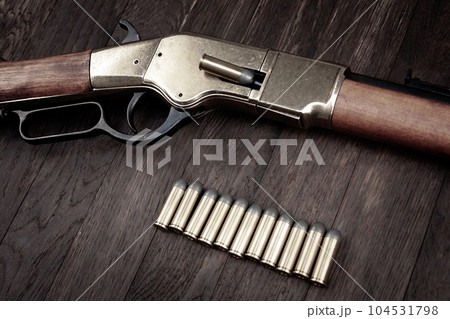 Old west guns. Lever action repeating rifles with ammunition Old west guns. Lever action repeating rifles with ammunition 104531798