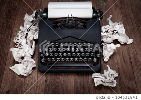 Retro vintage typewriter with crumpled paper on table 104531841