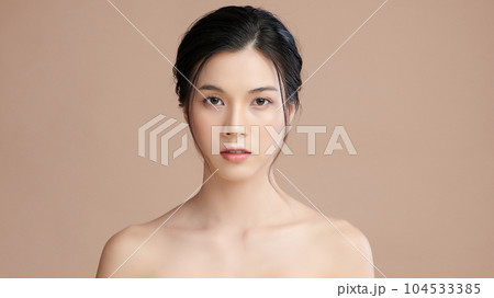 Beautiful young asian woman with clean fresh skin on beige background, Face care, Facial treatment, Cosmetology, beauty and spa, Asian women portrait. Beautiful young asian woman with clean fresh skin on beige background, Face care, Facial treatment, Cosmetology, beauty and spa, Asian women portrait. 104533385