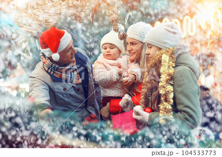 Family spending time at Christmas fair 104533773