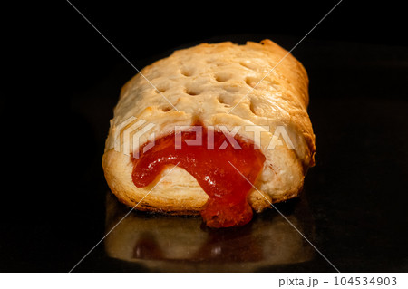Bun with red strawberry jam baking in electric oven: close up Bun with red strawberry jam baking in electric oven: close up 104534903