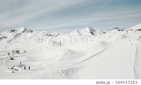People snowboarding skiing at ski resort. Skiers, snowboarders riding snowy mountain slope. Outdoor winter sport, scineric panoramic  104537283