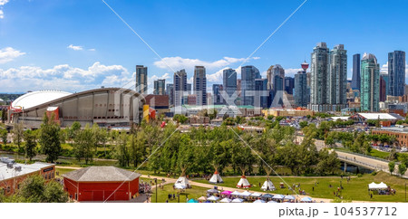 Calgary, Alberta, Canada. Jun 20, 2023. Calgary Downtown skyline during summer and Indigenous tipi's on display in the Indian Village with the dow 104537712