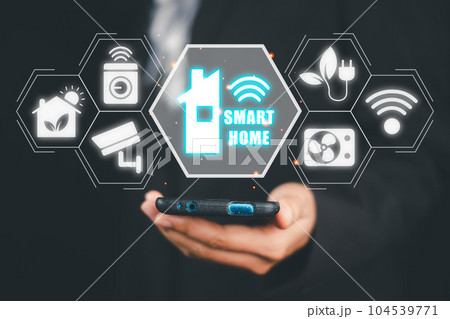Smart home automation control system, Man hand using smart phone with smart home control icon on VR screen, Innovation technology internet network concept. 104539771
