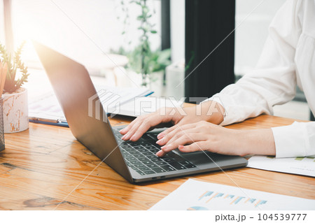 Bussinesswoman hand working on laptop computer at the table in the office, Business concept with copy space. Bussinesswoman hand working on laptop computer at the table in the office, Business concept with copy space. 104539777