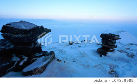 An ocean of clouds in the snowy mountains at dawn An ocean of clouds in the snowy mountains at dawn 104539989
