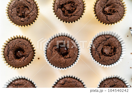 Filling s'mores cupcakes with chocolate ganache. Filling s'mores cupcakes with chocolate ganache. 104540242