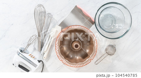 Flay lay. Kitchen tools for baking bundt cakes on the kitchen counter. 104540785