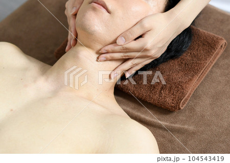 フェイシャルエステを受ける若い男性 フェイシャルエステを受ける若い男性 104543419