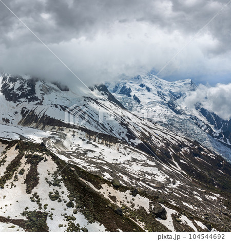 Mont Blanc rocky mountain massif overcast summer view from Aiguille du Midi Cable Car, Chamonix, French Alps Mont Blanc rocky mountain massif overcast summer view from Aiguille du Midi Cable Car, Chamonix, French Alps 104544692