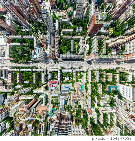 Aerial city view with crossroads and roads, houses, buildings, parks and parking lots. Sunny summer panoramic image Aerial city view with crossroads and roads, houses, buildings, parks and parking lots. Sunny summer panoramic image 104547058