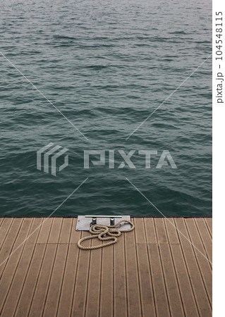Mooring bollard and blue sea 104548115