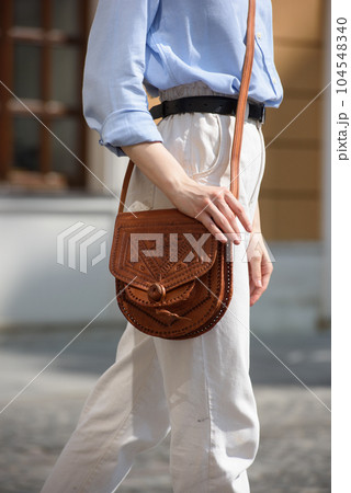 small light brown women's leather bag with a carved pattern. selective focus small light brown women's leather bag with a carved pattern. selective focus 104548340