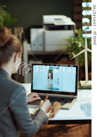 modern woman writes in notebook and having online webinar modern woman writes in notebook and having online webinar 104548790