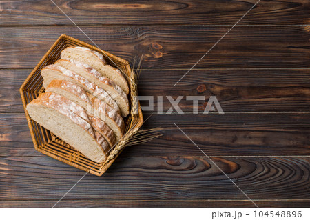 Freshly baked bread slices on basket against natural background. top view Sliced bread Freshly baked bread slices on basket against natural background. top view Sliced bread 104548896