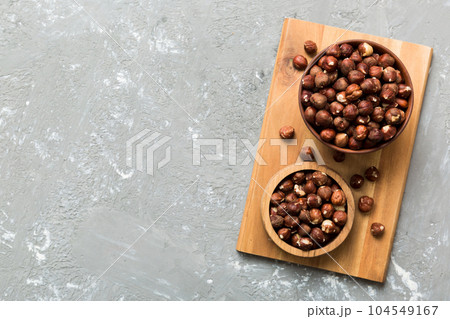 Wooden bowl full of hazelnuts on table background. Healthy eating concept. Super foods 104549167