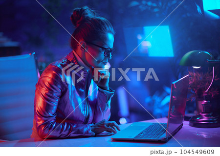 elegant woman in glasses using laptop and using video chat 104549609
