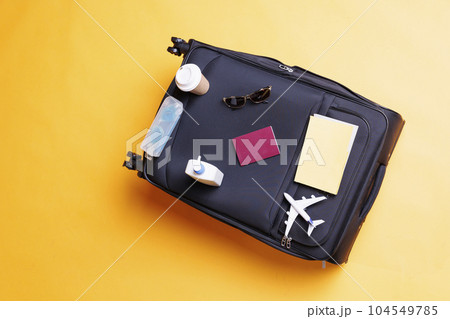 Big suitcase trolley bag in studio, empty space with luggage filled with multiple travelling things. Baggage with accessories and essential items used on vacation trip, international voyage. Big suitcase trolley bag in studio, empty space with luggage filled with multiple travelling things. Baggage with accessories and essential items used on vacation trip, international voyage. 104549785