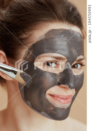 happy modern female with brush and cosmetic mask happy modern female with brush and cosmetic mask 104550991