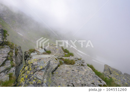romanian countryside scenery on a foggy day. mountainous nature landscape with steep rocky hills. summer vacations in fagaras romanian countryside scenery on a foggy day. mountainous nature landscape with steep rocky hills. summer vacations in fagaras 104551260