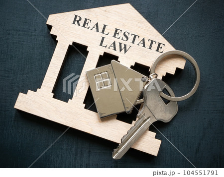 Plate with sign real estate law and metal key. Plate with sign real estate law and metal key. 104551791