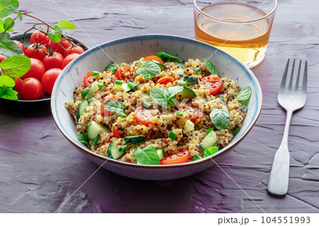 Quinoa tabbouleh salad in a bowl, a healthy dinner with tomatoes and mint Quinoa tabbouleh salad in a bowl, a healthy dinner with tomatoes and mint 104551993