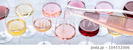 Rose wine poured into a glass at a tasting panorama. Rose, red, and white wine 104552006