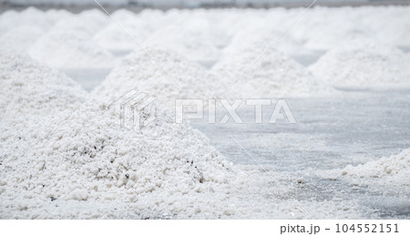 Sea salt farm. Pile of brine salt. Raw material of salt industrial. Sodium Chloride mineral. Evaporation and crystallization of sea water. White salt harvesting. Agriculture industry. Traditional farm 104552151