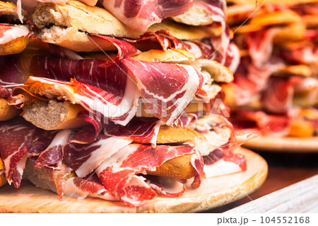 mouth watering sandwiches with jamon laid out in a slide on shop window 104552168