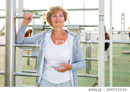 Old lady in outdoor workout station Old lady in outdoor workout station 104552214