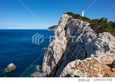 Lefkada island sea coast lighthouse on rocky cliff 104553740