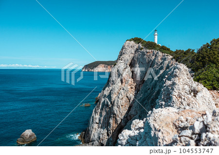 Lefkada island sea coast lighthouse on rocky cliff 104553747