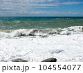 Mediterranean Sea waves crashing over rocks on a beach in stormy weather 104554077