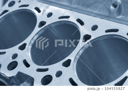 Close up scene the aluminum cylinder block in the light blue. Close up scene the aluminum cylinder block in the light blue. 104555827
