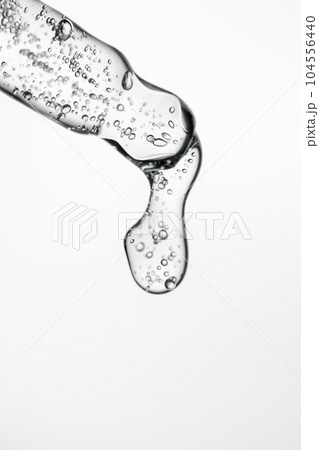 Transparent pipette with cosmetics on a light background. 104556440