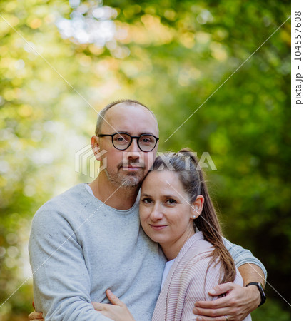 Portrait of happy couple in love, posing in forest. 104557608