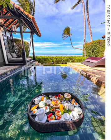Floating breakfast in pool in Lamai beach resort in Koh Samui, Thailand Floating breakfast in pool in Lamai beach resort in Koh Samui, Thailand 104558801