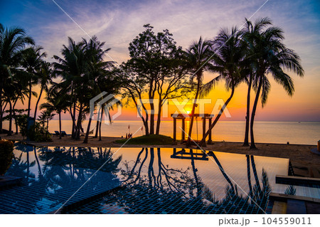 Beachfront sunrise with pool and palm trees in Hua Hin, Prachuap Khiri Khan, Thailand 104559011