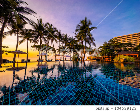 Beachfront sunrise with pool and palm trees in Hua Hin, Prachuap Khiri Khan, Thailand 104559125