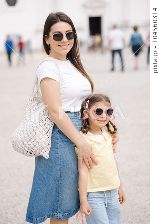Mom and daughter walking in city. Happy family spend time together Mom and daughter walking in city. Happy family spend time together 104560314