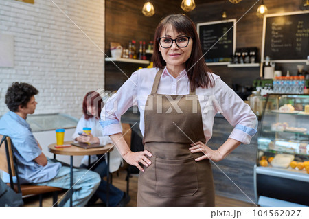 Portrait of confident smiling middle aged woman coffee shop owner, worker Portrait of confident smiling middle aged woman coffee shop owner, worker 104562027