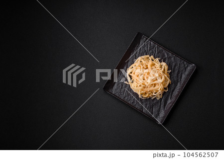 Delicious dried squid in the form of shavings with salt and spices 104562507